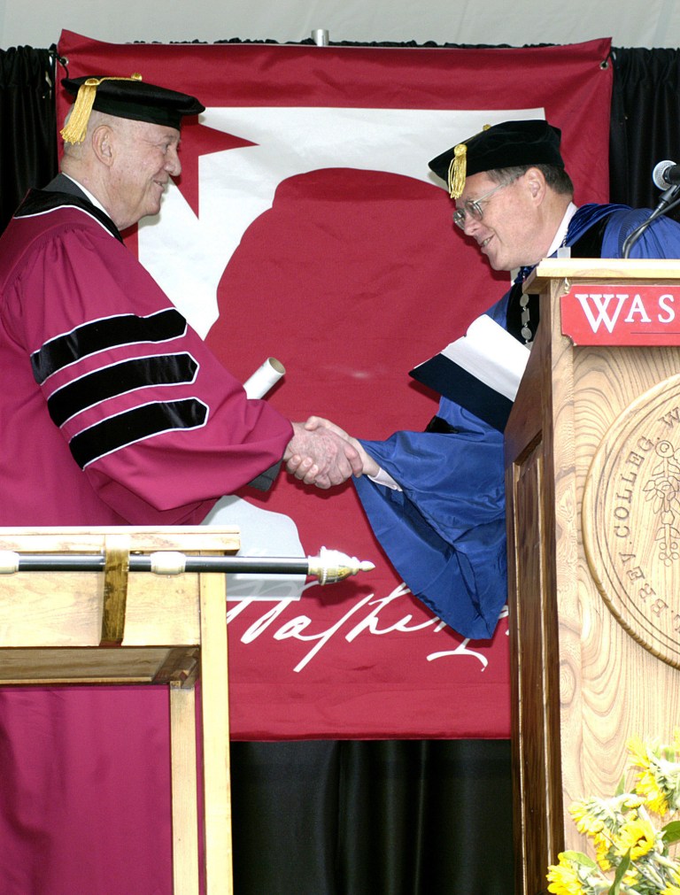 FILE - In this Sunday, May 22, 2005, file photo, John S.D. Eisenhower, left, receives an honorary Doctor of Letters degree from Washington College President Baird Tipson during commencement exercises in Chestertown, Md. isenhower, the son of a five-star general turned president who forged his own career in the U.S. Army and then chronicled the history of the American military in numerous books, died Saturday, Dec. 21, 2013. He was 91. (AP Photo/Star Democrat, Charlie Campbell, File)