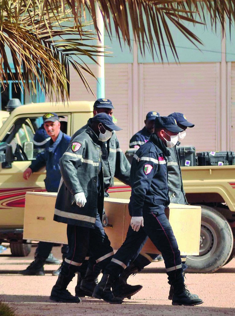 Algerian firemen carry a coffin containing the body of a person killed during the hostage situation in a gas plant at the morgue in Ain Amenas, Monday, Jan. 21, 2013. At least 81 people have been reported dead, including 32 Islamist militants, after a bloody, four-day hostage situation at Algeria's remote Ain Amenas natural gas plant. (AP Photo/Anis Belghoul)
