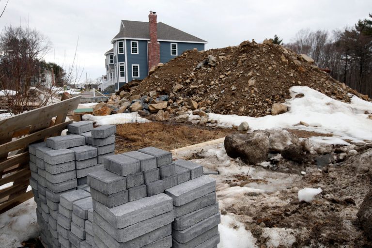 In this Friday, March 21, 2014, photo,  a single family housing construction is underway in North Andover, Mass. The Commerce Department reports on U.S. construction spending in February on Tuesday, April 1, 2014. (AP Photo/Elise Amendola)
