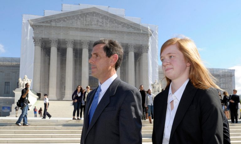 Abigail Fisher, the Texan involved in the University of Texas affirmative action case, and Edward Blum, who runs a group working to end affirmative action, walk outside the Supreme Court in October 2012. The 5th Circuit Court of Appeals will rehear Fisher's case. (AP Photo/Susan Walsh)