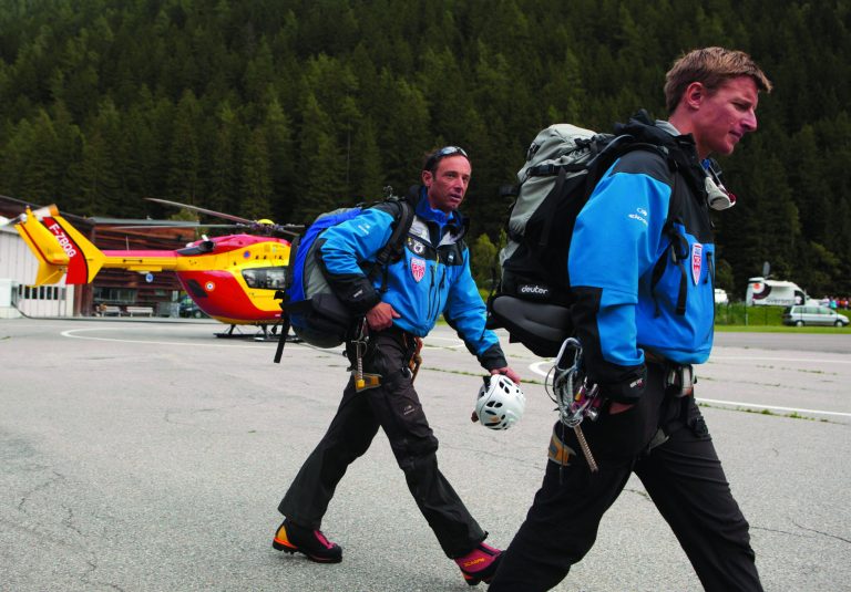 French rescue workers arrive at a helicopter landing area after an avalanche in the French Alps near Chamonix, France, swept at least nine climbers to their deaths, Thursday, July 12, 2012. About 28 climbers from Switzerland, Germany, Spain, France, Denmark and Serbia were believed to be involved in the expedition caught in the avalanche, according to the local gendarme service and Danish Foreign Ministry. (AP Photo/Anja Niedringhaus)