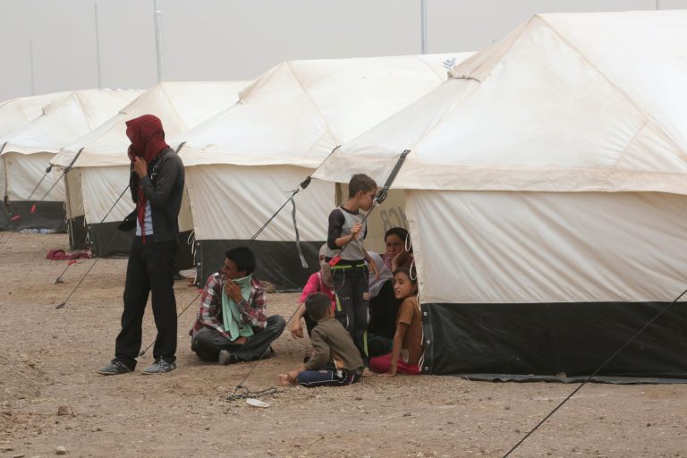 Displaced Iraqis settle at a new camp outside the Bajid Kandala camp in Feeshkhabour town, Iraq, Tuesday, Aug. 19, 2014. Some 1.5 million people have been displaced by fighting in Iraq since the Islamic State's rapid advance began in June, and thousands more have died. The scale of the humanitarian crisis prompted the U.N. to declare its highest level of emergency last week. (AP Photo/Khalid Mohammed)