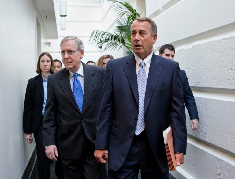 House Speaker John Boehner of Ohio, right, walks with Senate Minority Leader Mitch McConnell of Ky., left, as they make their way to a GOP strategy session on Capitol Hill. (AP/J. Scott Applewhite)