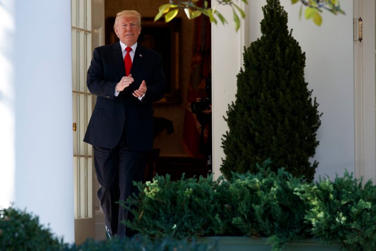 President Donald Trump walks out of the Oval Office before an event with NCAA championship teams at the White House, Friday, Nov. 17, 2017, in Washington. (AP Photo/Evan Vucci)