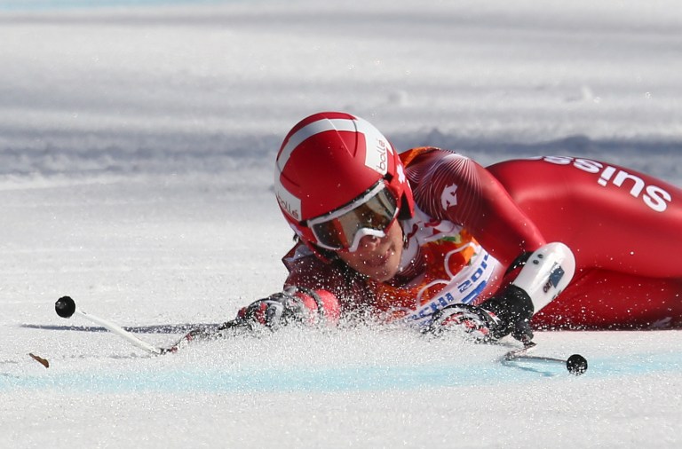 Switzerland's Dominique Gisin falls in the women's super-G at the Sochi 2014 Winter Olympics, Saturday, Feb. 15, 2014, in Krasnaya Polyana, Russia. (AP Photo/Alessandro Trovati)