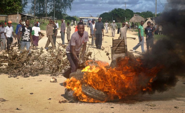 Residents barricade a road with burning tyres and other roadblocks as they protest against the recent killings and what they claimed was the government's failure to provide them with enough security, in the village of Kibaoni just outside the town of Mpeketoni, about 60 miles (100 kilometers) from the Somali border on the coast of Kenya Tuesday, June 17, 2014. Kenya's President Uhuru Kenyatta, in a nationally televised address Tuesday, blamed political leaders inside Kenya for carrying out two nights of deadly attacks that killed at least 60 people in coastal communities, saying that despite claims of responsibility from al-Shabab, the Islamic extremists were not behind it. (AP Photo)