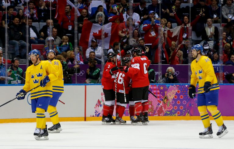 Team Sweden skates back to the bench as Canada celebrates a goal during the first period of the men's gold medal ice hockey game at the 2014 Winter Olympics, Sunday, Feb. 23, 2014, in Sochi, Russia. (AP Photo/Julio Cortez)