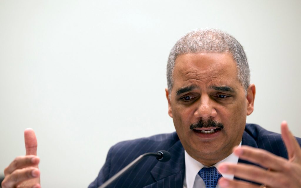 There stands Eric Holder, blocking the schoolhouse door
