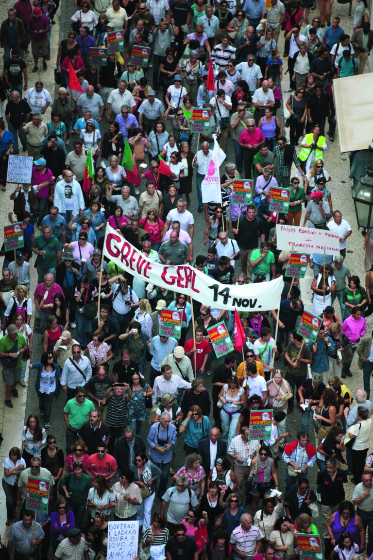 A banner calling for a general strike on November 14 is carried by demonstrators during a protest march against austerity measures as they head to the Portuguese parliament in Lisbon Saturday, Oct. 13 2012. Unemployment figures in Portugal have soared since the introduction of austerity measures to fight the country's debt crisis. (AP Photo/Armando Franca)