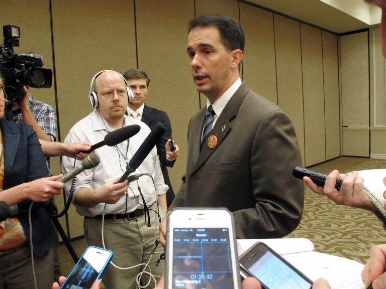 Wisconsin health care advocates want Gov. Scott Walker to say what will happen with 77,000 adults being shifted off Medicaid in January if they are not able to get coverage through the new health insurance exchange in time. (AP/Scott Bauer)