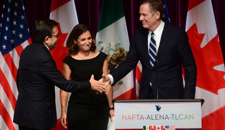 Mexico's Secretary of Economy Ildefonso Guajardo Villarreal, left, shakes hands with U.S. Trade Representative Robert Lighthizer as Canada's Foreign Affairs Minister Chrystia Freeland looks on at a news conference on the NAFTA negotiations in Ottawa on Wednesday, Sept. 27, 2017. (Sean Kilpatrick/The Canadian Press via AP)