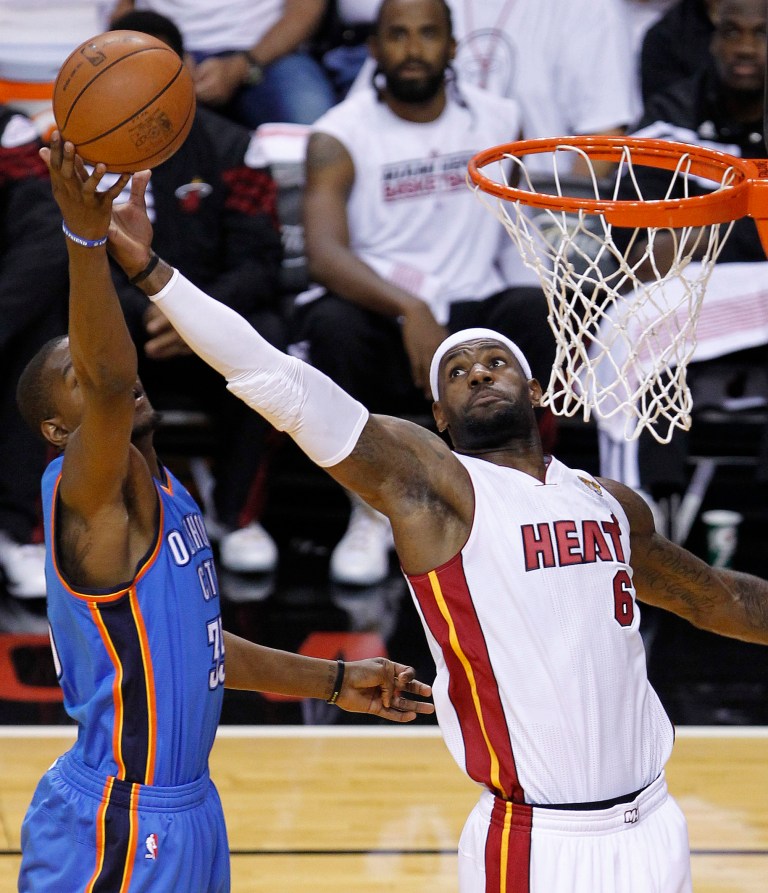   Miami Heat small forward LeBron James (6) shoots as Oklahoma City Thunder small forward Kevin Durant (35) defends during the first half at Game 3 of the NBA Finals basketball series, Sunday, June 17, 2012, in Miami. (AP Photo/Wilfredo Lee)  