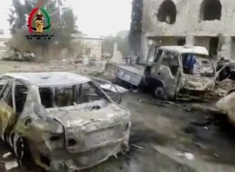 In this image made from video obtained from the Shaam News Network, which has been authenticated based on its contents and other AP reporting, vehicles smolder after an explosion outside a mosque in Yadouda, Syria, Friday, Feb. 14, 2014. A car bomb blew up outside a mosque in a rebel-held village in southern Syria as worshippers were leaving after Friday prayers, killing dozens of people and filling clinics and hospitals with the wounded, anti-government activists said. (AP Photo/Shaam News Network)