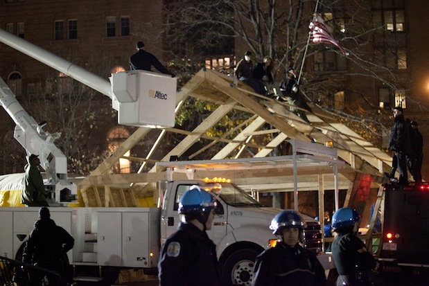 Occupy D.C. protesters sit on a structure that was erected in the early hours of Sunday morning, Dec 4, 2011.