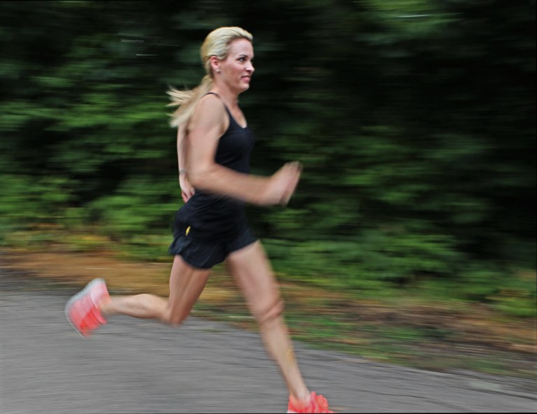   In this photo taken July 17, 2012 Suzy Favor Hamilton runs at her home in Shorewood Hills a suburb of Madison, Wis. The three-time Olympian has admitted leading a double life as an escort. She apologized Thursday, Dec. 20, 2012, after a report by The Smoking Gun website said she had been working as a prostitute in Las Vegas. (AP Photo/Milwaukee Journal-Sentinel, Michael Sears)  