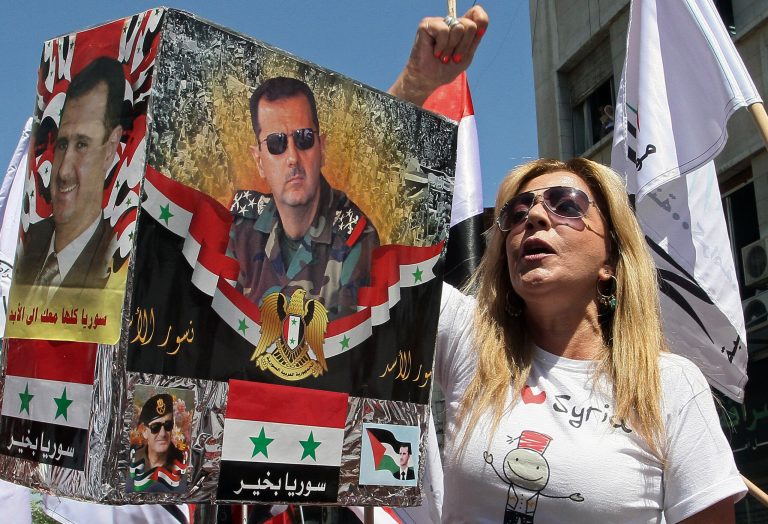 Members of Syrian national parties and syndicates stage a sit in at Youssef al-Azmeh Square during a protest against a possible U.S. military strike against their country in Damascus, Syria, on Monday. (AP Photo)