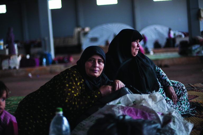 Two Syrian women take a rest within a refugee camp in the border with Turkey, near Azaz village, Syria, Sunday, Sept. 30, 2012. (AP Photo/ Manu Brabo)
