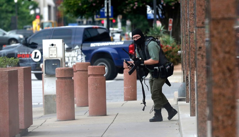 An armed shooter stands near the Earle Cabell Federal Building Monday, June 17, 2019, in downtown Dallas.