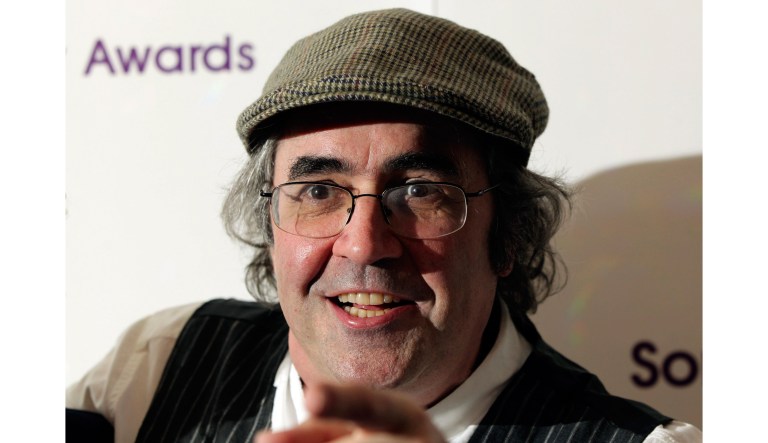 In this May 13, 2013 photo, Danny Baker poses for a photo in London. A BBC DJ has been fired after using a picture of a chimpanzee in a tweet about the royal baby born to Meghan the Duchess of Sussex and her husband Prince Harry. Danny Baker tweeted Thursday, May 9, 2019 that he has been fired after posting an image of a couple holding hands with a chimpanzee dressed in clothes and the caption: "Royal baby leaves hospital." 