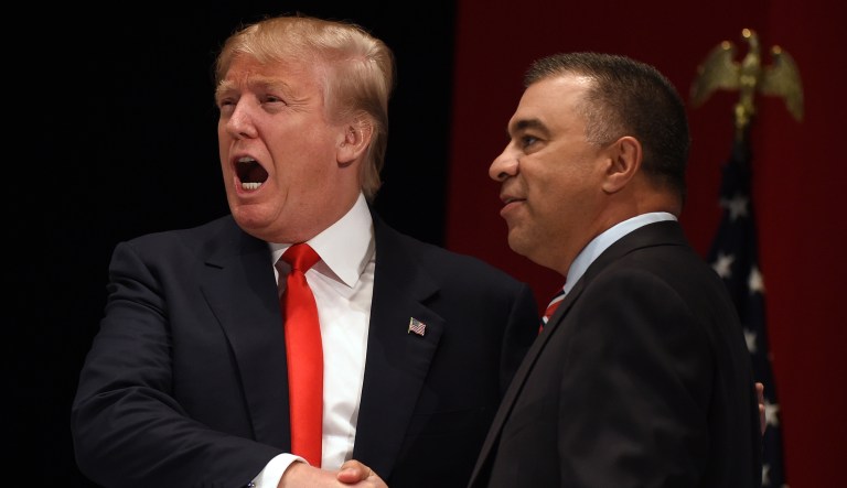 Donald Trump, left, reacts to the crowd as he shakes hands with co-host David Bossie at the Freedom Summit, Saturday, May 9, 2015, in Greenville, S.C.