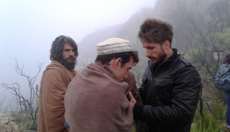 Director David Helling speaks with actor Edaan Moskowitz, who plays the role of Isaac, while Nicolas Mouawad, who plays Abraham, looks on while on the set of His Only Son.