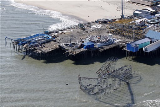 FILE - In this Friday, Nov. 9, 2012 file photograph, the roller coaster from an amusement pier rests in the Atlantic Ocean in Seaside Heights, N.J., after the region was pounded by Superstorm Sandy. The remains of the roller coaster that was knocked off a New Jersey amusement pier by Superstorm Sandy and partially submerged in the Atlantic Ocean might be left there as a tourist attraction. Seaside Heights Mayor Bill Akers tells WNBC-TV in New York that officials have not made a decision on whether to tear down the coaster. But the mayor says he's working with the Coast Guard to see if the coaster is stable enough to leave it alone because he believes it would make 