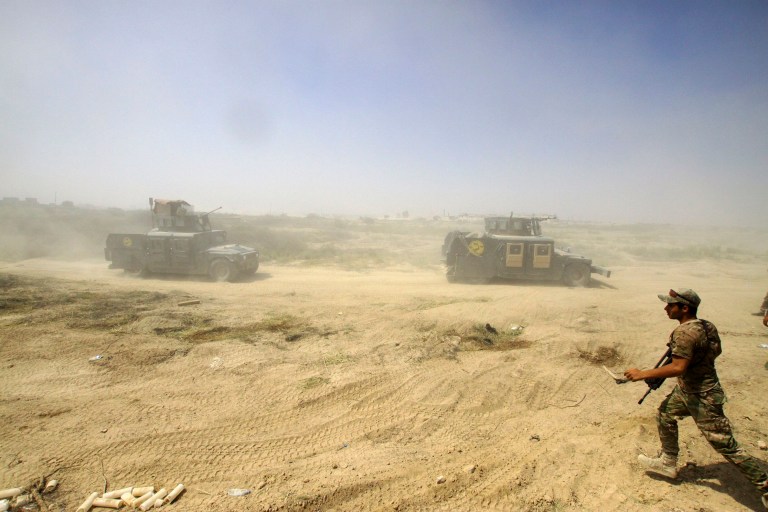 Cook took a harder line by refusing to confirm whether any U.S. troops were wounded. (AP Photo/Anmar Khalil)