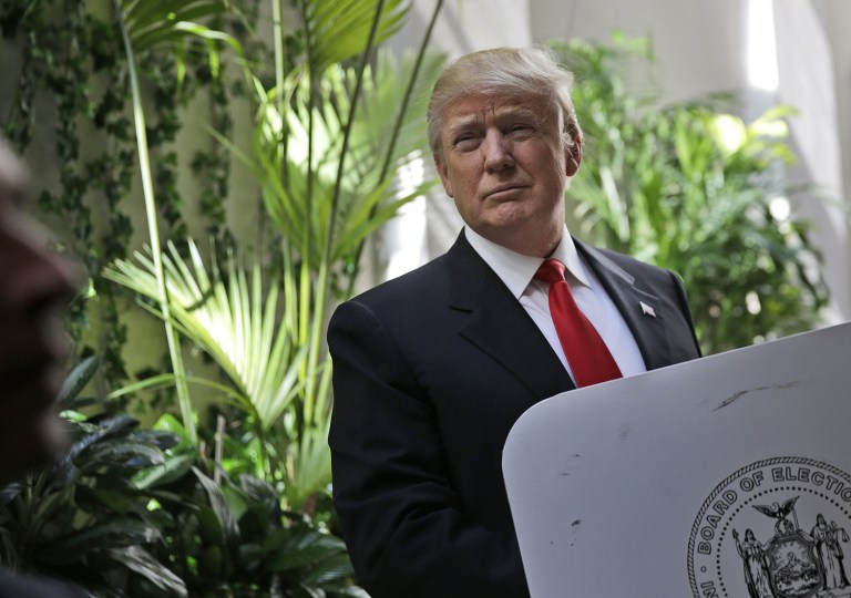 Republican presidential candidate Donald Trump looks up as he fills in his ballot in New York, Tuesday, April 19, 2016. (AP Photo/Seth Wenig)