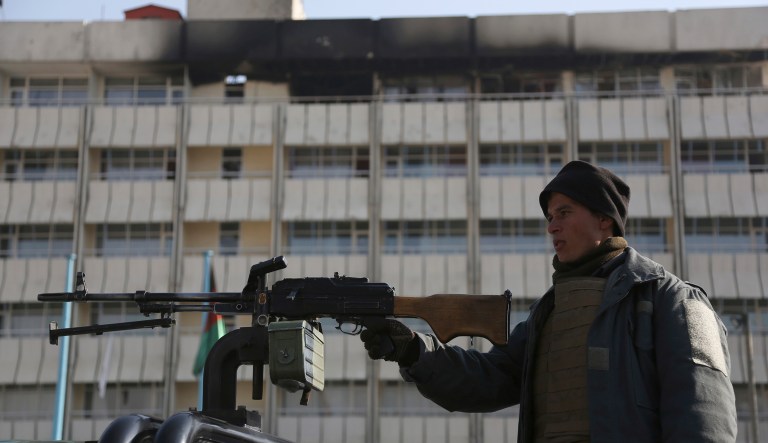 An Afghan police officer stands guard in front of the Intercontinental Hotel in Kabul on Tuesday, Jan. 23, 2018. (AP Photo/Rahmat Gul)