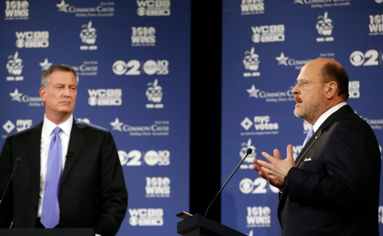 New York City Republican mayoral candidate Joe Lhota, right, speaks as Democratic candidate Bill de Blasio listens during the second of three debates prior to the Nov. 5 general election, Tuesday, Oct. 22, 2013. Lhota went on the offensive again Monday, this time attacking opponent Bill de Blasio for his role in green-lighting Brooklyn's sprawling Atlantic Yards development. (AP Photo/ Kathy Willens, Pool)