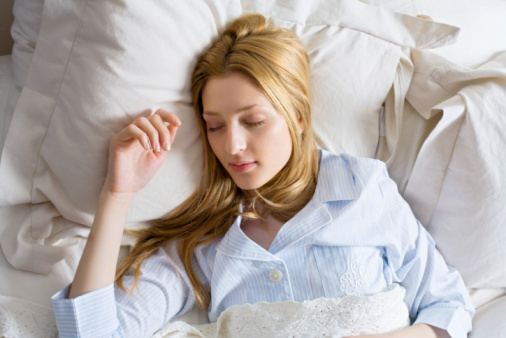 Woman sleeping in bed.