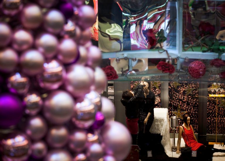   A woman dresses up a mannequin at a fashion boutique inside a shopping mall in Beijing Monday, Dec. 17, 2012. Chinaâs new Communist Party leaders are promising reforms aimed at reducing reliance on exports to drive growth and more spending if needed to prop up a shaky economic recovery. (AP Photo/Andy Wong)  