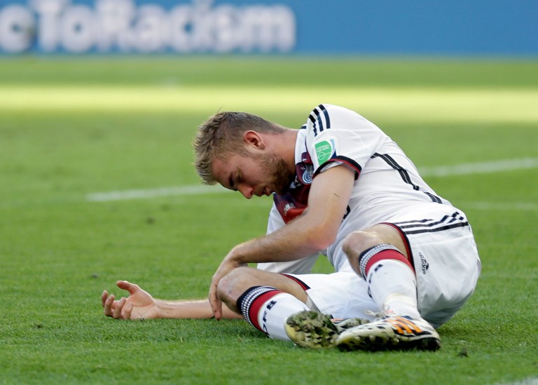 Germany's Christoph Kramer lies on the pitch after getting hit in the face by Argentina's Ezequiel Garay's shoulder during the World Cup final soccer match between Germany and Argentina at the Maracana Stadium in Rio de Janeiro, Brazil, Sunday, July 13, 2014. (AP Photo/Natacha Pisarenko)