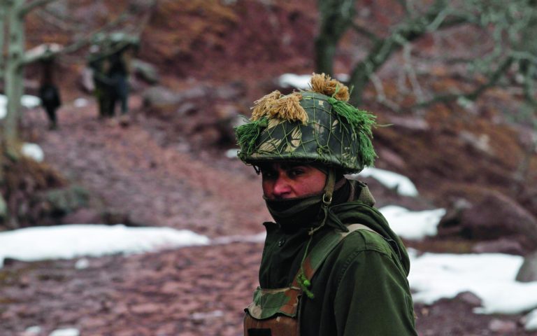 An Indian army soldier patrols near the Line of Control (LOC), the line that divides Kashmir between India and Pakistan, in Churunda village, about 150 Kilometers (94 miles) northwest of Srinagar, India, Tuesday, Jan. 15, 2013. India's relations with archrival Pakistan 