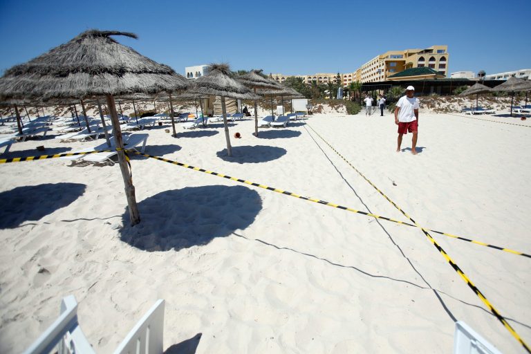 A worker passes by the scene of a shooting in Sousse, Tunisia, Saturday, June 27, 2015. (AP Photo/Darko Vojinovic)