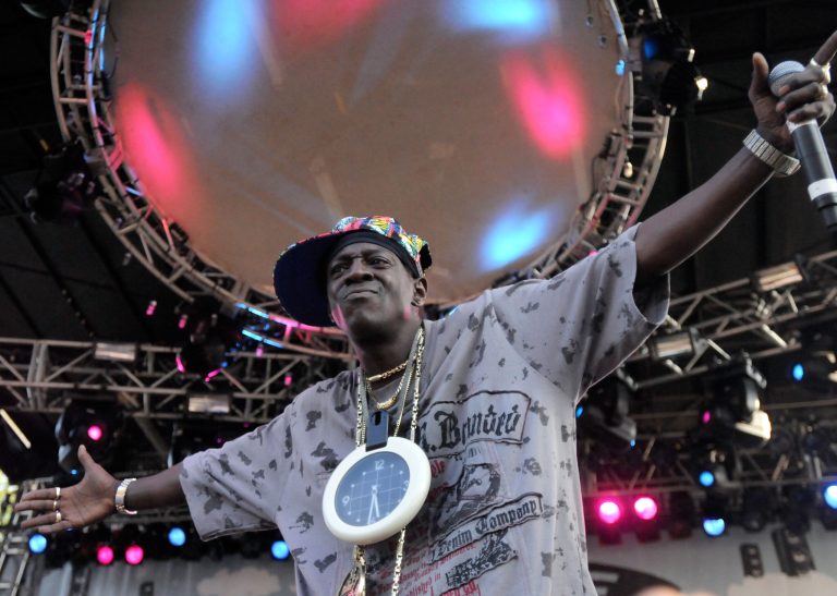 FILE - In this Aug. 30, 2009 file photo, Flavor Flav of Public Enemy performs during the Virgin Mobile Freefest concert at Merriweather Post Pavilion in Columbia, Md. Entertainer Flavor Flav has a scheduling conflict between a court date in Las Vegas and his induction with the rap group Public Enemy into the Rock and Roll Hall of Fame in Los Angeles. He's due for arraignment Thursday, April 18, 2013, on felony charges that he chased and threatened his longtime girlfriend's 17-year-old son with a butcher knife during a family argument last October. (AP Photo/Steve Ruark, File)