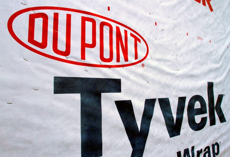 FILE - This Jan. 23, 2012, file photo, shows a DuPont logo on sheets of Tyvek insulation covering a wall of a home under construction in Springfield, Ill.  DuPont's announced Thursday April 17, 2014 agricultural sales suffered and its operating costs rose during extensive winter storms that dragged on first-quarter earnings, although volumes increased in the company's industrial segments and margins improved in almost every one of them. (AP Photo/Seth Perlman, File)