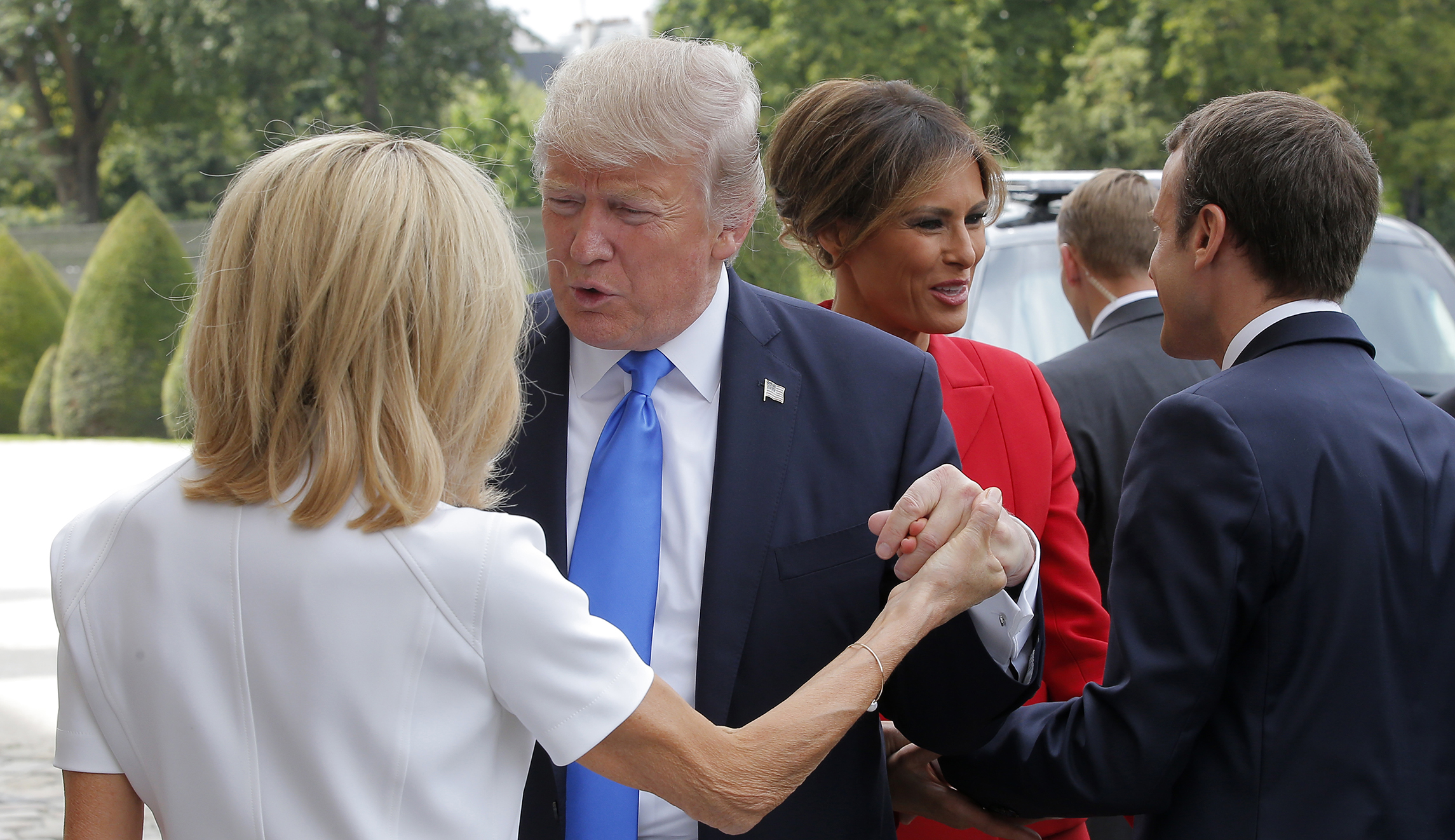 Watch: Trump has yet another awkward handshake with Emmanuel Macron and his wife