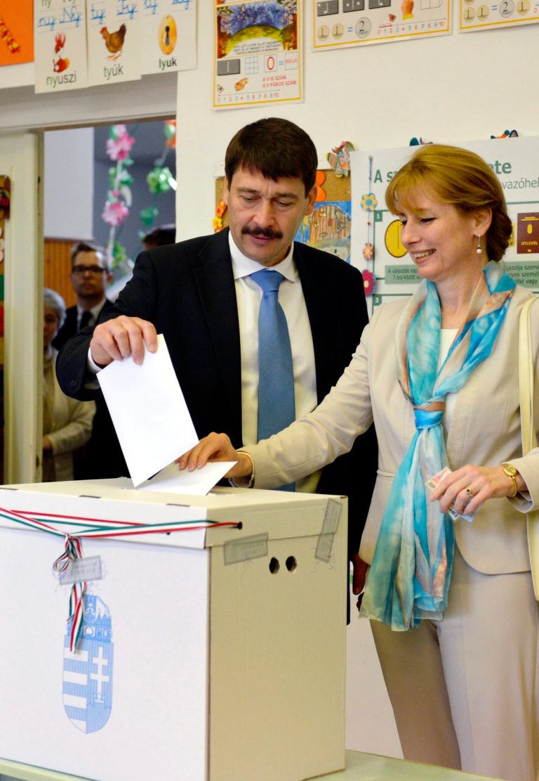 Hungarian President Janos Ader and his wife Anita Herczegh cast their vote at a polling station in Budapest during the parliamentary elections in Hungary,  Sunday April 6,  2014.  Hungary's governing party is tipped to win parliamentary elections Sunday, while a far-right party is expected to make further gains, according to polls. Prime Minister Viktor Orban's Fidesz party and its small ally, the Christian Democrats, are expected to win easily and they may even retain the two-thirds majority in the legislature gained in 2010 which allowed them to pass a new constitution, adopt unconventional economic policies, centralize power and grow the state's influence at the expense of the private sector. (AP Photo/Laszlo Beliczay)