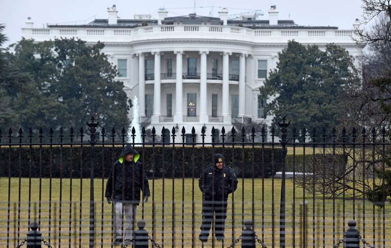 Secret Service officers search the south grounds of the White House. The White House was placed on lockdown at about 10:30 a.m. Tuesday morning after Secret Service found a suspicious package located on the grounds. (AP Photo/Susan Walsh)