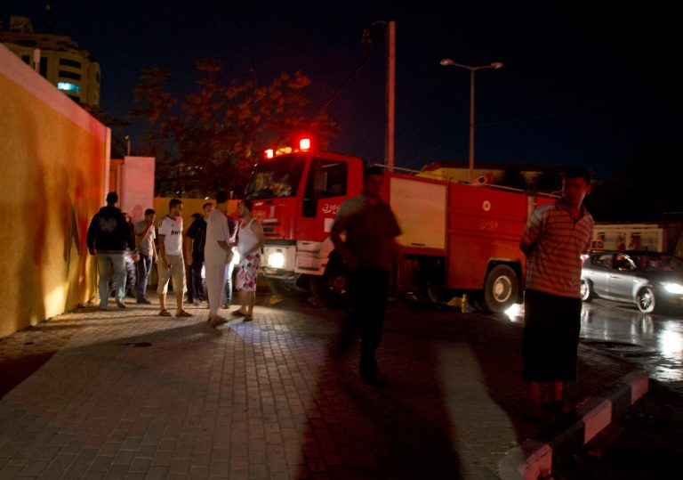In this Tuesday, Oct. 7, 2014 photo, a fire truck arrive to the French cultural center in Gaza after an explosion late Tuesday. Officials at the center say no one was in the building at the time of the blast and that most of the damage was in the facility's restaurant. (AP Photo/Khalil Hamra)