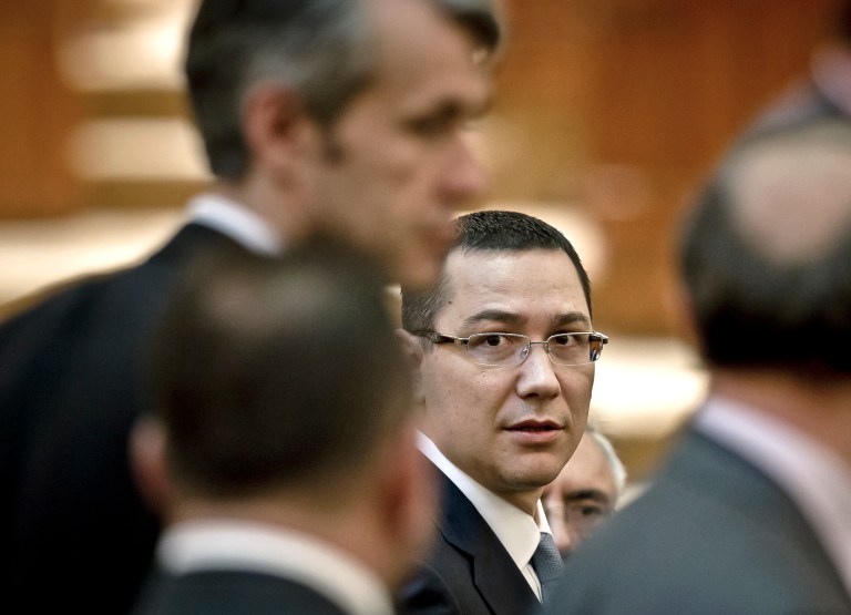   FILE - A file picture taken on May 7, 2012, Romanian Premier designate Victor Ponta, right, is seen before a parliament session in Bucharest, Romania. Romania's president on Monday, Dec. 17, 2012, reappointed the prime minister to his post despite a bitter feud between the two top officials. Traian Basescu said he had designated Victor Ponta as prime minister after Ponta's center-left governing alliance won some 68 percent of seats in Dec. 9 parliamentary elections. (AP Photo/Vadim Ghirda, File)  