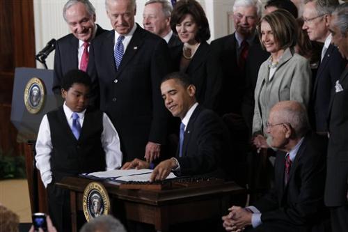 President Barack Obama reaches for a pen to sign the health care bill, Tuesday, March 23, 2010, in the East Room of the White House in Washington. (AP Photo/Charles Dharapak)