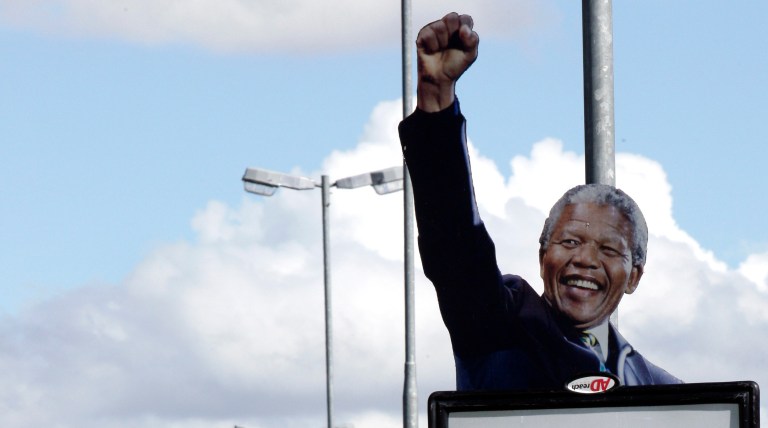   A poster with a picture of former South African President Nelson Mandela in Bloemfontein, South Africa, Saturday, Dec. 15, 2012, ahead of the ruling party elective conference where the current President Jacob Zuma will fight for a second term as head of the ruling party. Mandela on Friday, Dec 14 2012 entered the seventh day of a hospital stay for a lung infection as questions grow about where he is receiving treatment. The 94-year-old patriarch of South Africa's democracy has been hospitalized since Saturday, first undergoing tests and later being diagnosed with the ailment. (AP Photo/Themba Hadebe)  