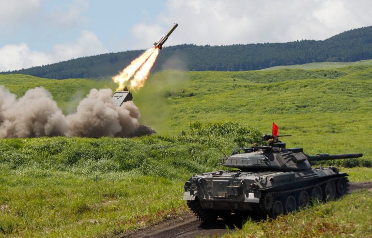   FILE - In this Aug. 21, 2012 file photo, an anti-land mine missile is launched during the annual live-firing exercise by Japan Ground Self-Defense Force at the Higashi Fuji training range in Gotemba, southwest of Tokyo. Japan's military is kept on a very short leash under a war-renouncing constitution written by U.S. officials whose main concern was keeping Japan from rearming soon after World War II. But if Japan's soon-to-be prime minister Shinzo Abe has his way, the status quo may be in for some change. (AP Photo/Koji Sasahara, File)  