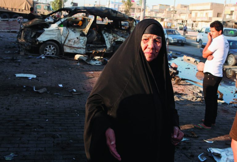 People inspect the aftermath of Saturday's car bomb explosion, in the Shiite enclave of Sadr City, in Baghdad, Iraq, Sunday, Oct. 28, 2012. Iraqi insurgents unleashed a string of bombings and other attacks that killed and wounded scores of people, primarily targeting the country's Shiite community on Saturday, Oct. 27, 2012, in a challenge to government efforts to promote a sense of stability by preventing attacks during a major Muslim holiday. (AP Photo/Karim Kadim)