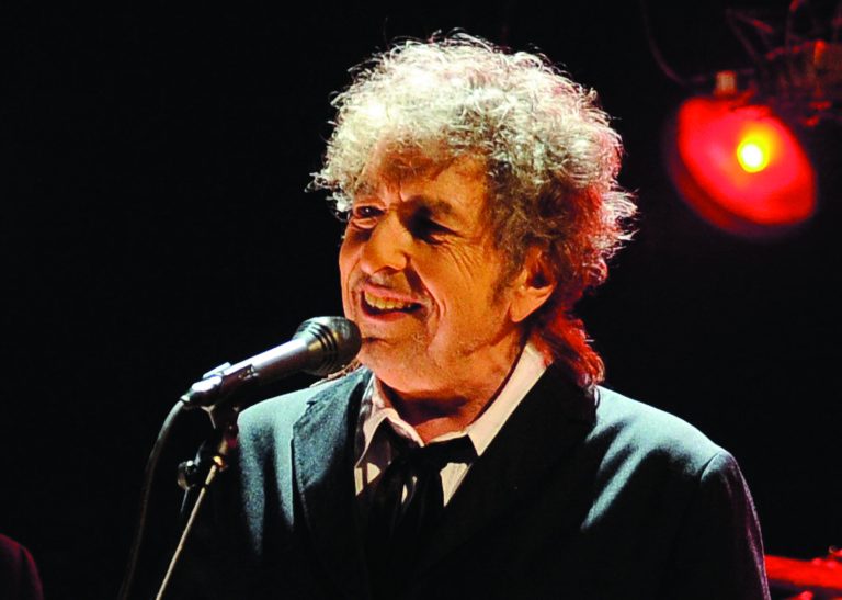 FILE - In this Jan. 12, 2012 file photo, Bob Dylan performs in Los Angeles. Fifty years into his career as a recording artist and a week away from release of an extraordinary new CD, Dylan spent his Tuesday evening where he seems to feel most comfortable -- on a stage. (AP Photo/Chris Pizzello, File)