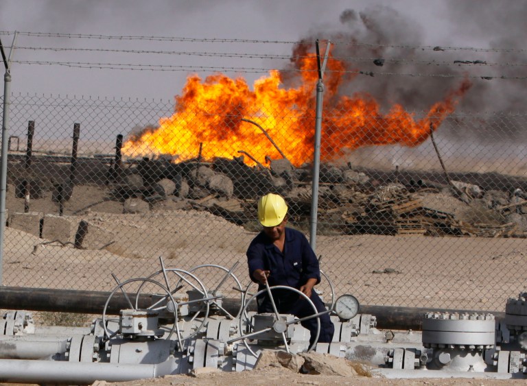 An Iraqi worker operates valves at the Rumaila oil refinery, near the city of Basra, 340 miles southeast of Baghdad, Iraq, Sunday, Dec. 13, 2009. (AP Photo/Nabil al-Jourani)