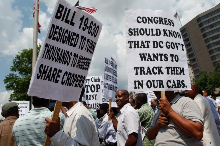 D.C. taxi drivers protest outside the John A. Wilson building over the overhaul to the city's cabs. (Graeme Jennings/Examiner)
