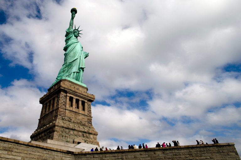 Tourists visit the Statue of Liberty in New York Harbor, Sunday, Oct. 13, 2013, in New York. The Statue of Liberty reopened to the public after the state of New York agreed to shoulder the costs of running the site during the partial federal government shutdown. (AP Photo/John Minchillo)